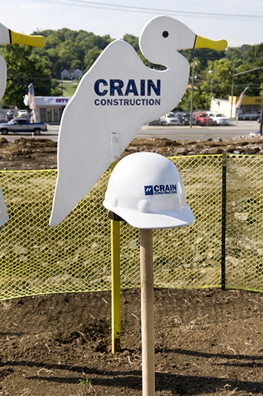 crain construction sign that is the shape of a bird outside
