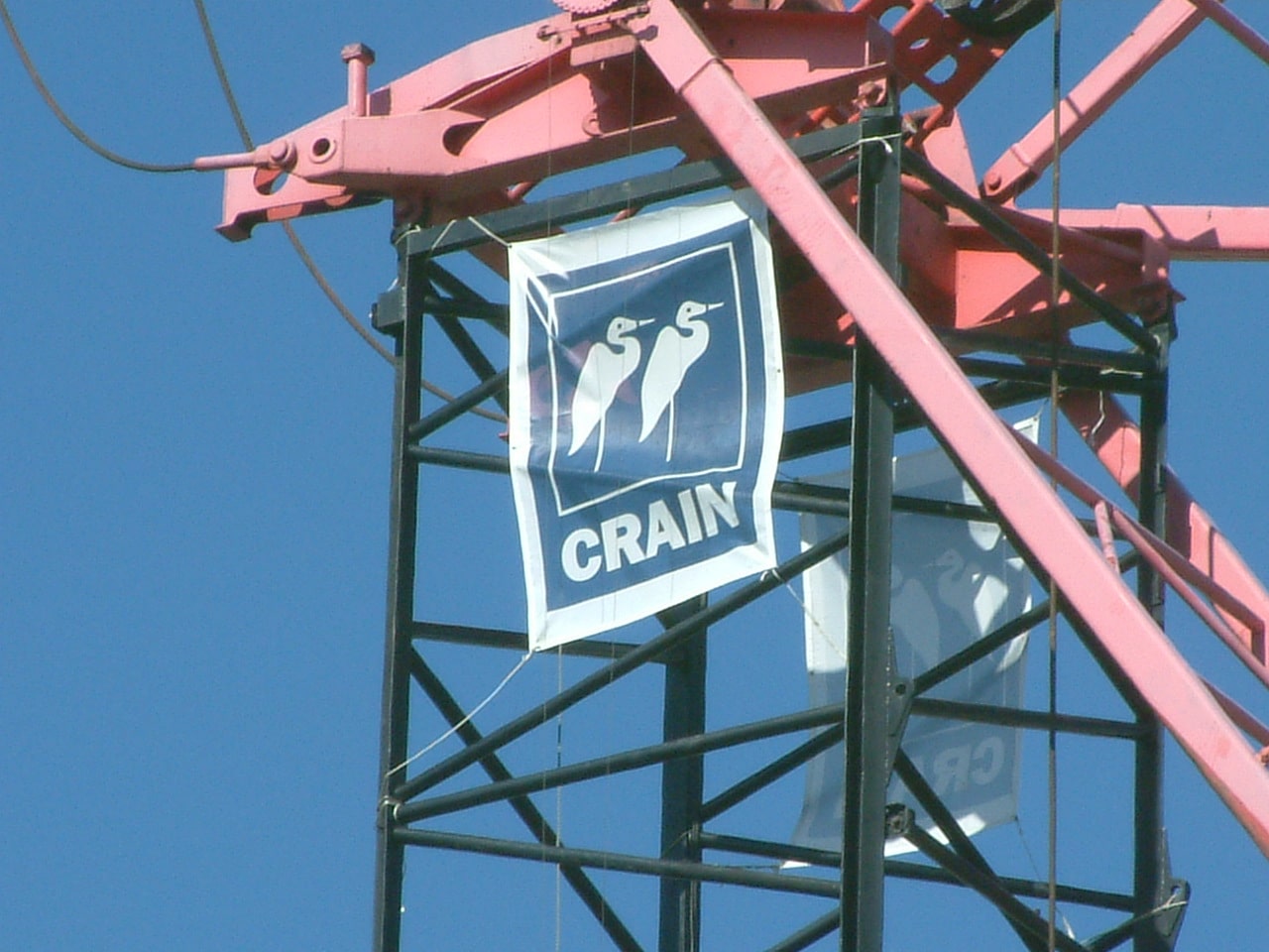 Crain Construction banner waving in the wind off scaffolding in the sky