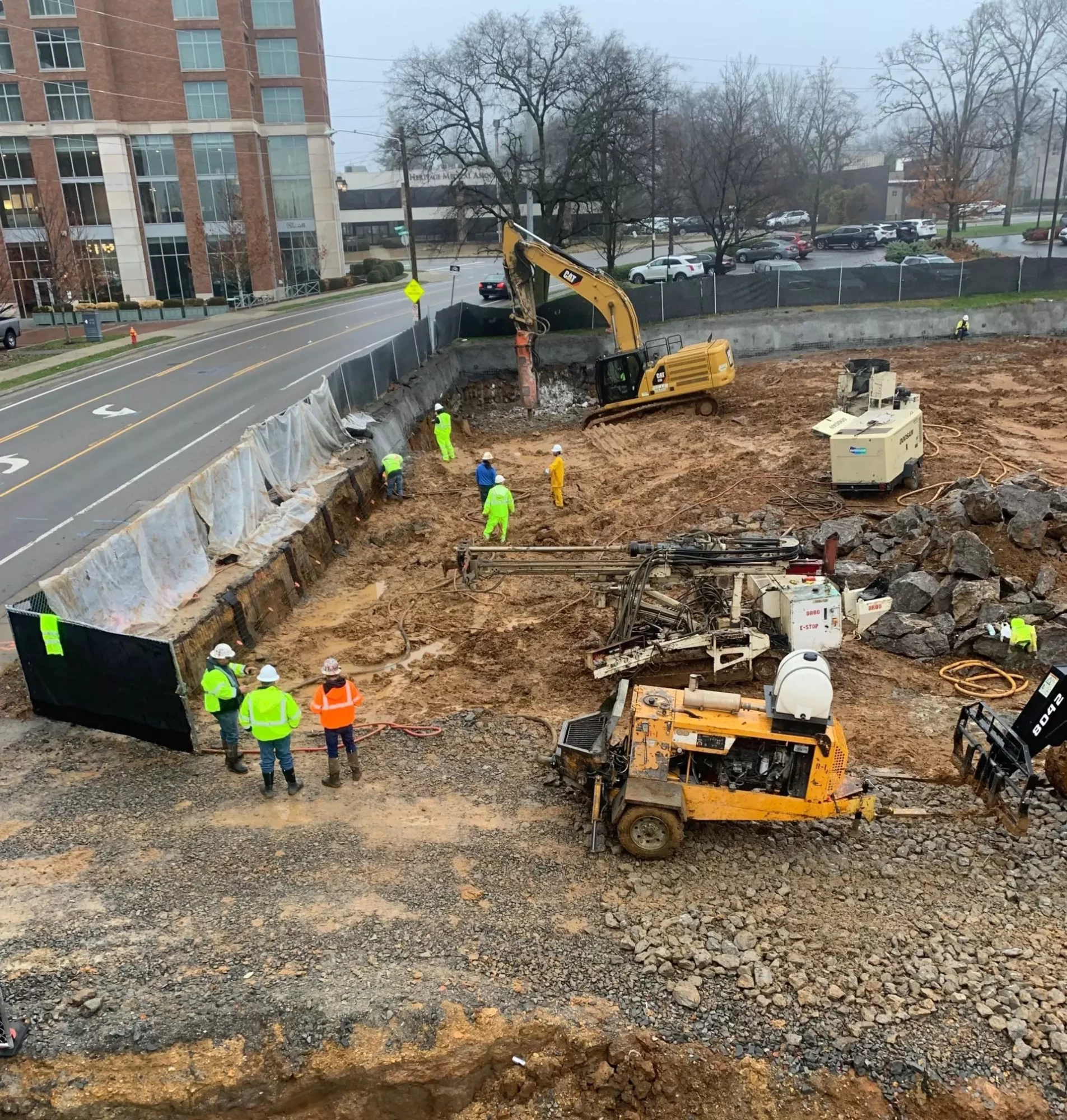 workers and machinery on commercial construction site