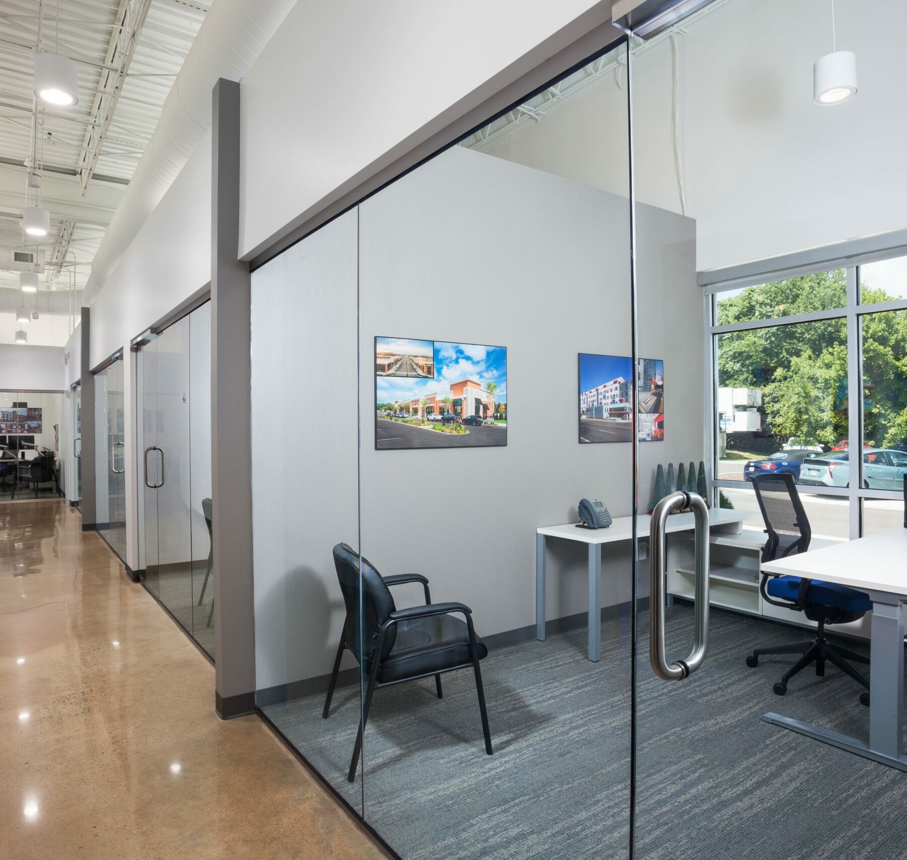 Inside of the Crain Construction Office, featuring all-glass doors and exposed ceilings.