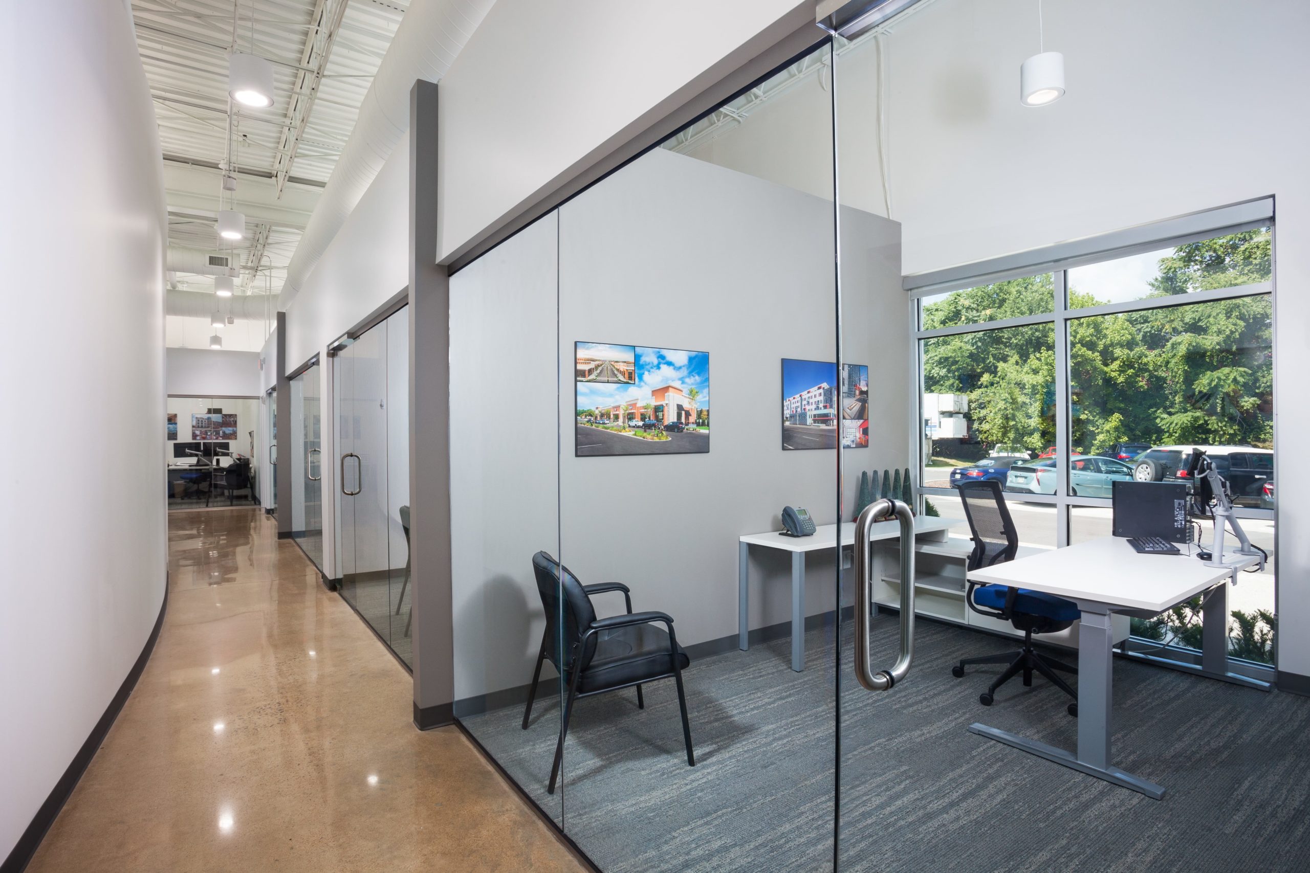 Inside of the Crain Construction Office, featuring all-glass doors and exposed ceilings.