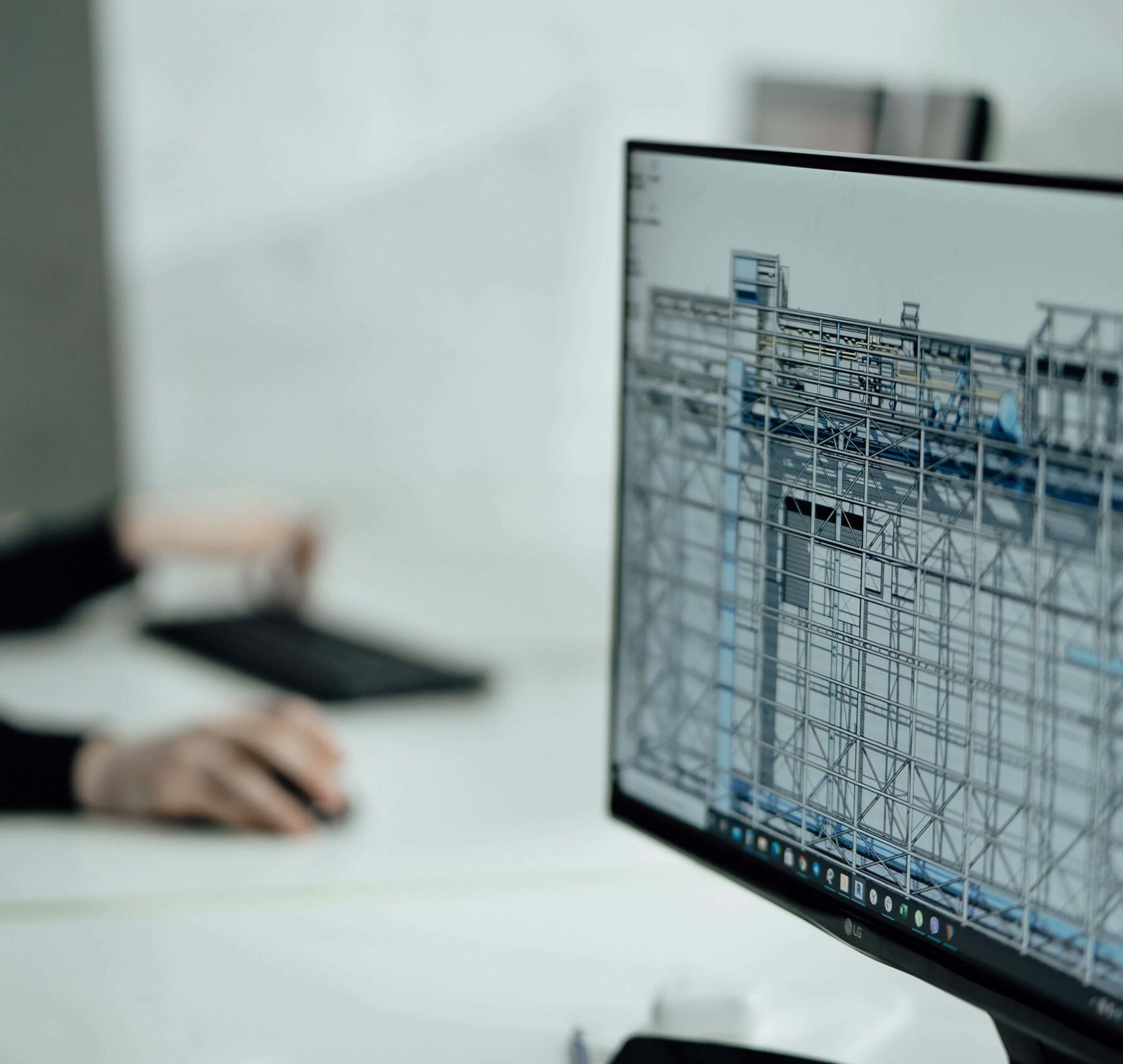 Computer displaying preconstruction software in an office setting