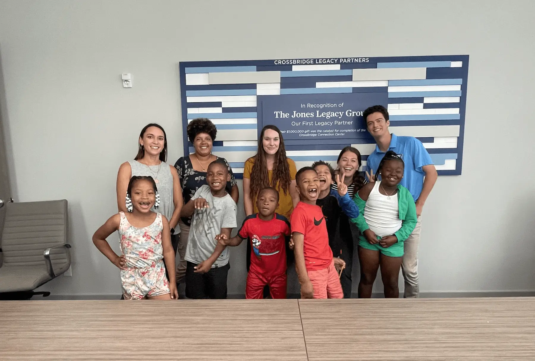 group of people standing in front of a sign