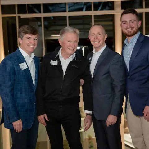 Crain Construction Leadership posing for a photo in suits