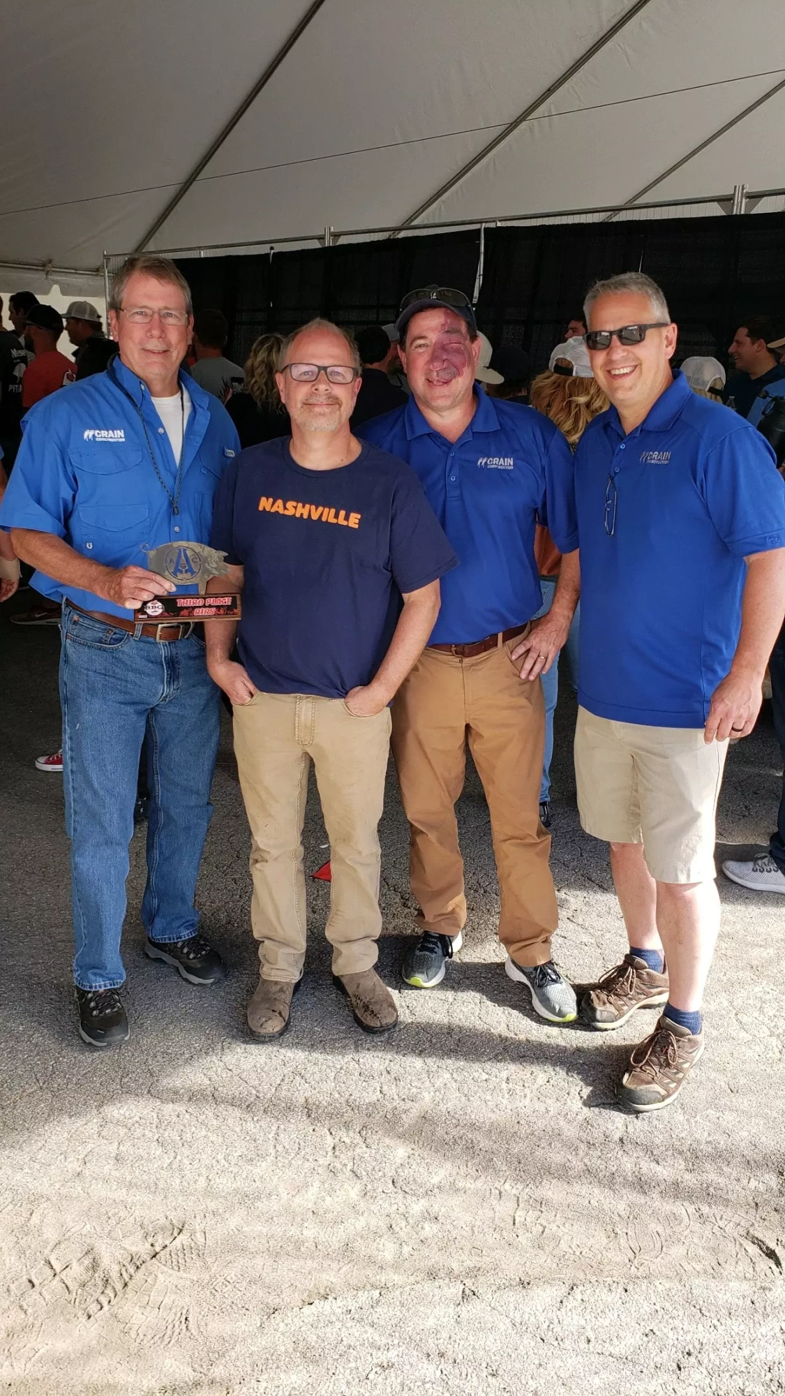 Crain Construction employees holding a trophy