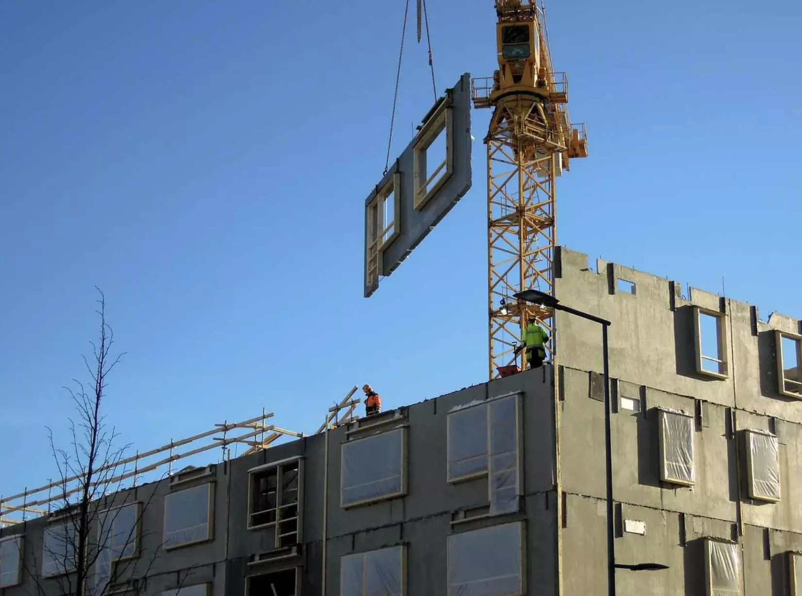 modular building being constructed by crane