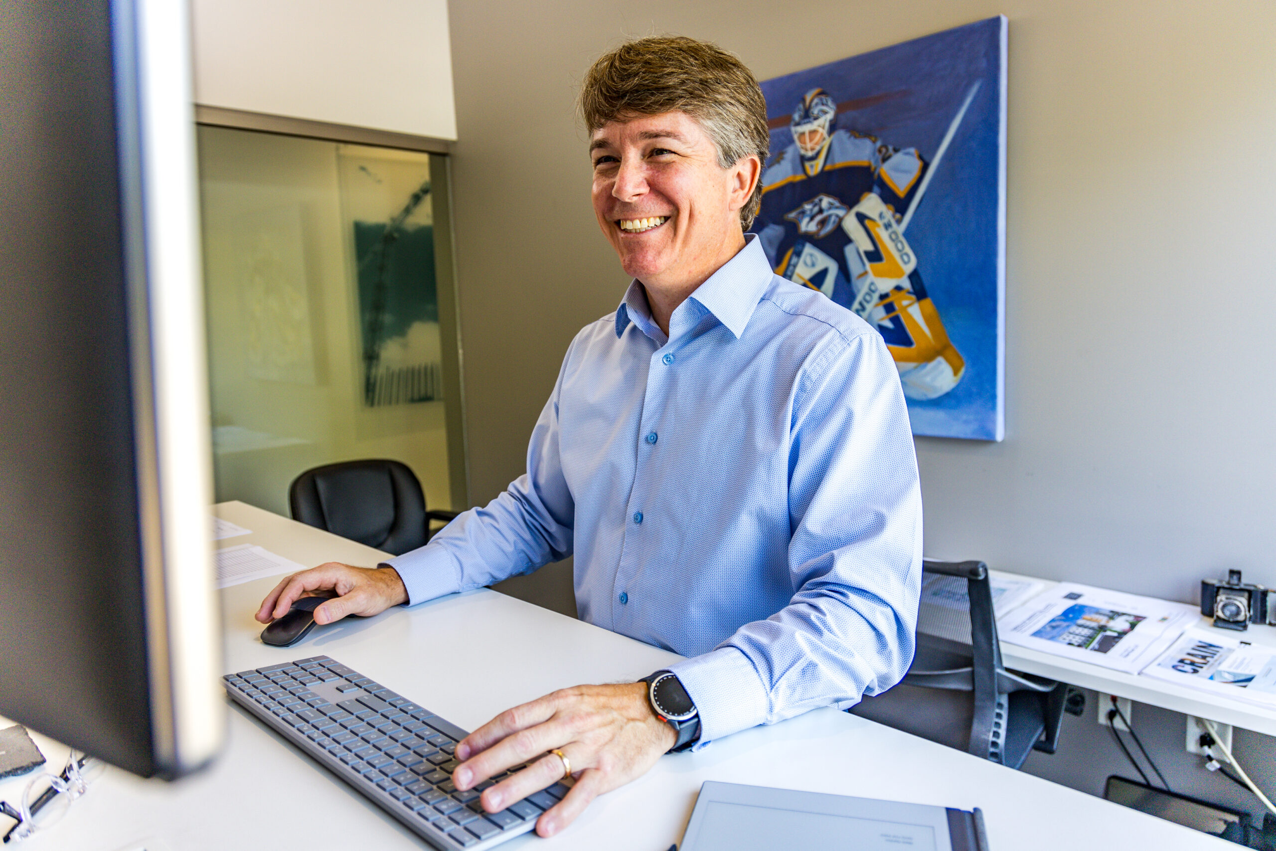 crain construction office employee smiling at computer