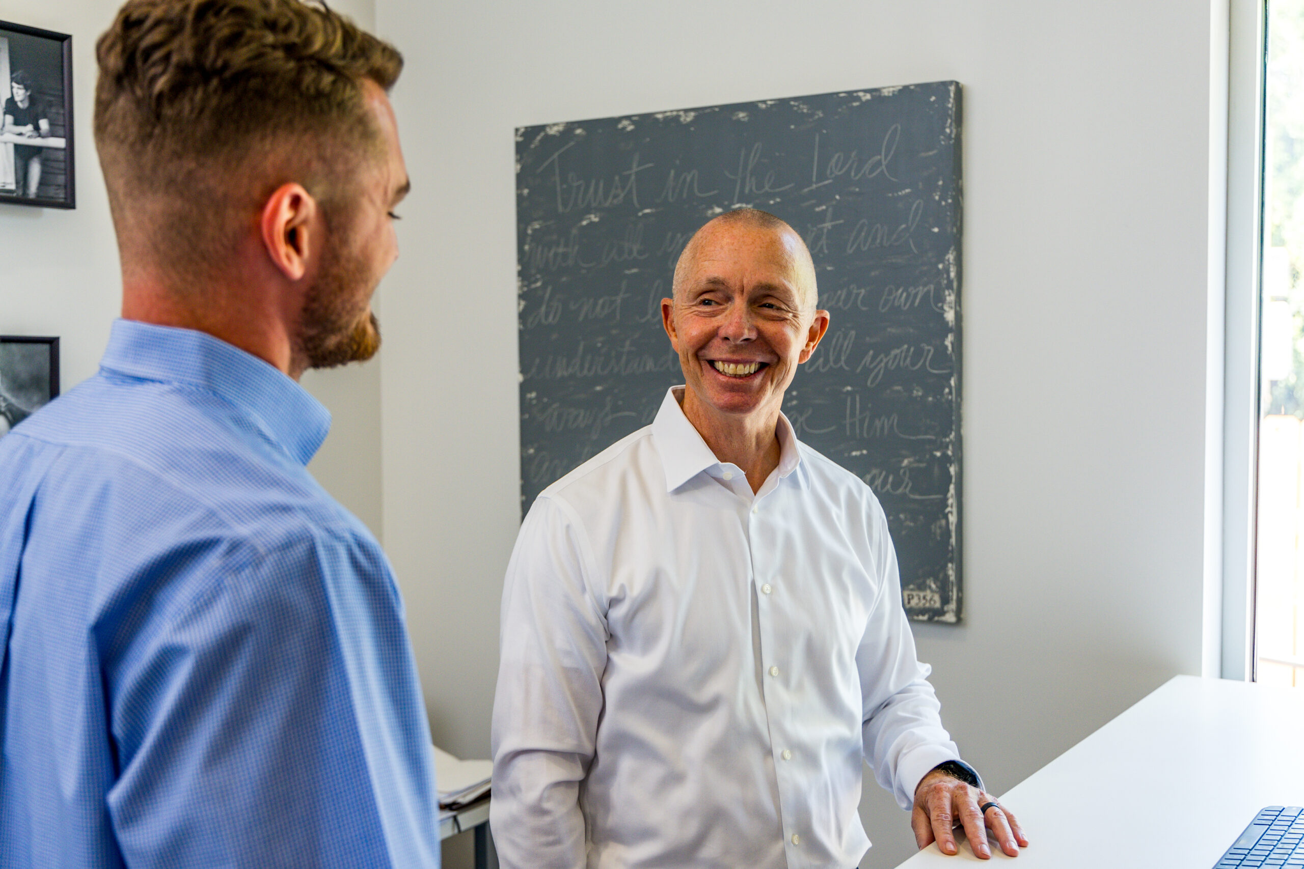 crain construction employees discussing a project in the office