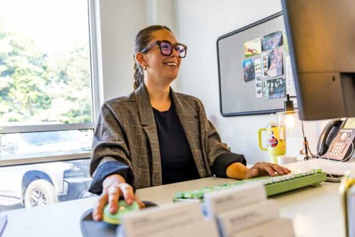 crain construction employee at her desk