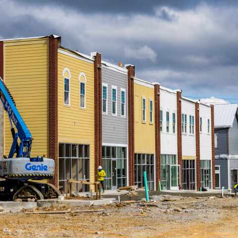 cherry picker on village green retail construction site nashville