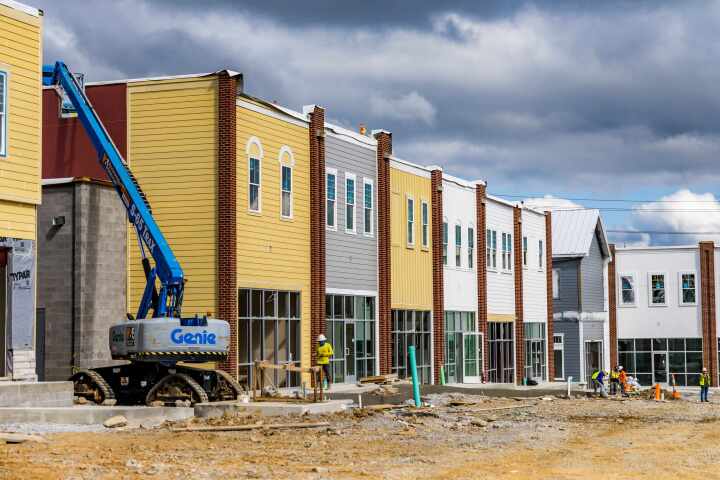 cherry picker on village green retail construction site nashville