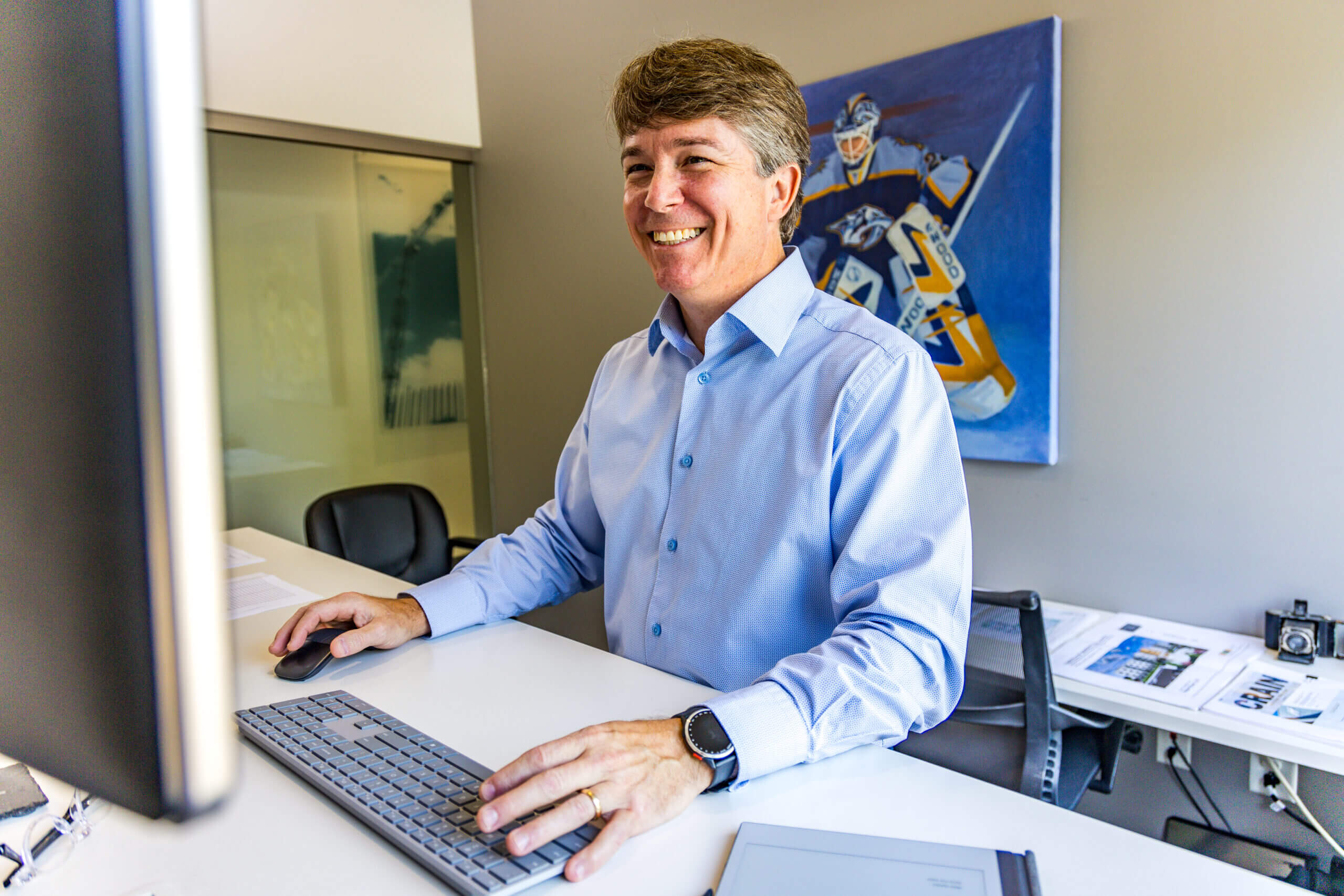 crain construction employee standing at office desk
